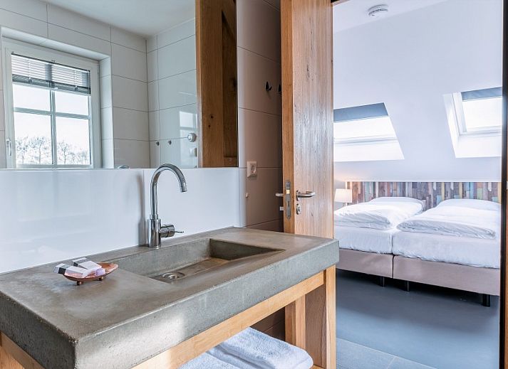 Spacious living room in Group Residence Nieuw Leven Texel, Den Burg, with modern furnishings and lots of natural light.