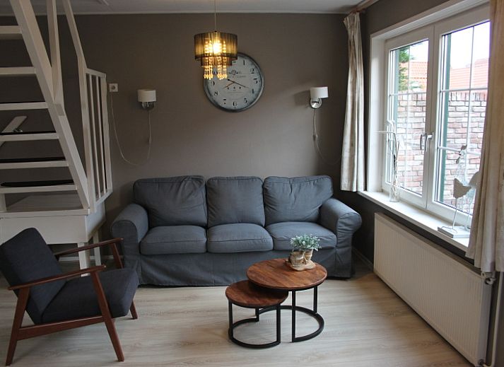 Cozy living room in vacation home De Molen, Den Burg, Texel with comfortable seating area.