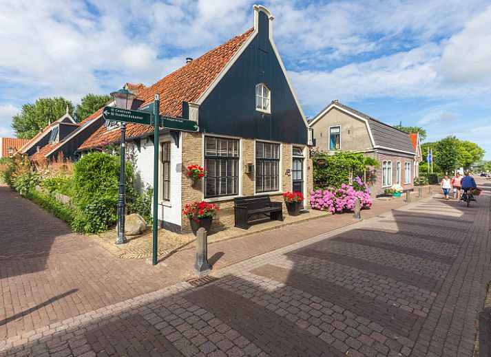 Gezellige woonkamer van Appartement De Kwikstaart, Den Burg, Texel, met comfortabele zitruimte en warme houten accenten.