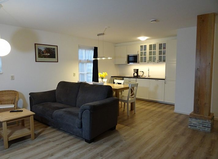 Das Ferienhaus Vigilant in Den Hoorn, Texel, mit Reetdach und gruener Fassade, ideal fuer einen entspannten Aufenthalt auf den Watteninseln.