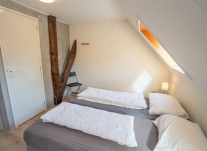Gezellige woonkamer van Eendenkooi vakantiehuis in Den Hoorn Texel met comfortabele zitruimte.