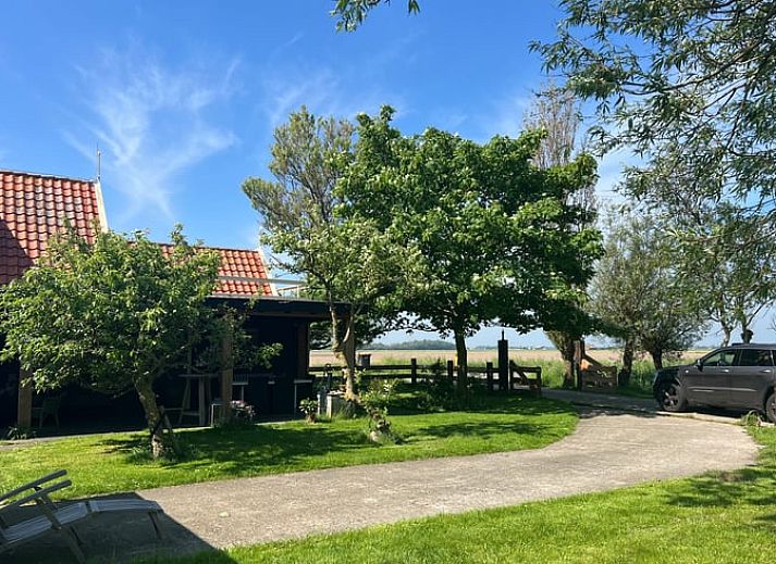 Covered porch at Holiday home in Oosterend Texel, Wadden Islands, ideal for outdoor relaxation.