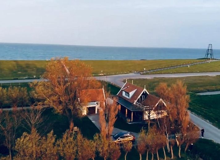 Covered porch at Holiday home in Oosterend Texel, Wadden Islands, ideal for outdoor relaxation.