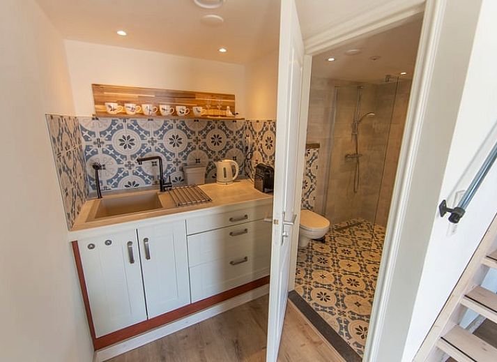 Luftaufnahme des Ferienhauses in Oosterend, Texel, mit Blick auf Meer und Wiesen.