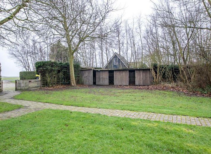 Moderne woonkamer in vakantiehuis Nieuwlanderweg 69, De Koog, Texel, met comfortabele zithoek en veel natuurlijk licht.