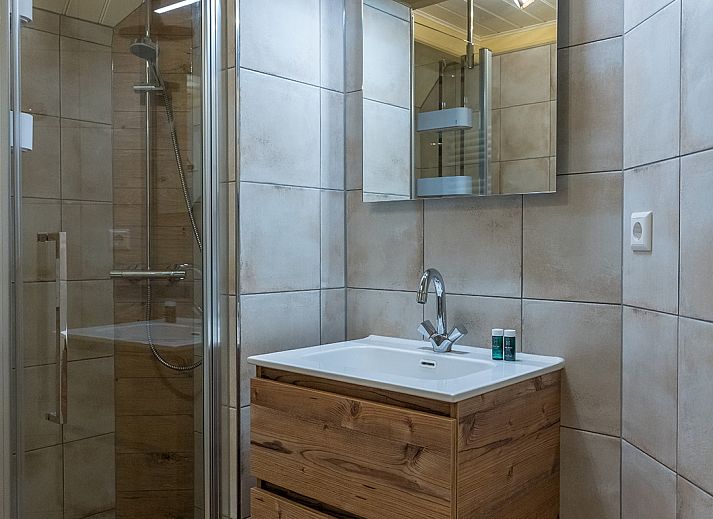 Cozy living room of Zilverling vacation home in Oosterend, Texel overlooking the terrace.