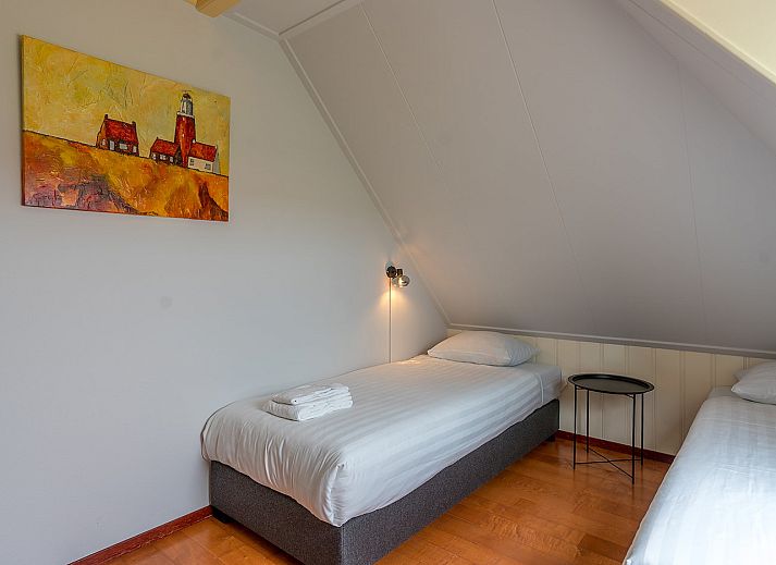 Cozy living room of Zilverling vacation home in Oosterend, Texel overlooking the terrace.