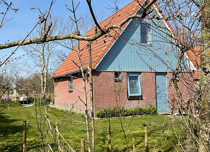 Type II - nr. 79 Zilvermeeuw in Oosterend, Texel biedt een charmant vakantiehuis met rode dakpannen en groene tuin.