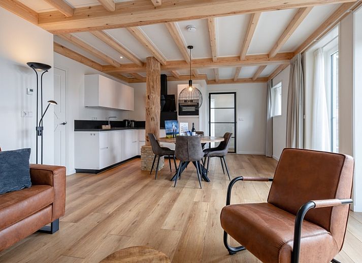 Charming exterior of Apartment C in Oudeschild, Texel, with colorful garden and terrace.