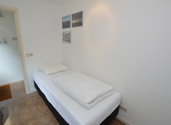 Lichte woonkamer van Vakantiehuis de Parel 182 in De Dennen, Texel met uitzicht op de tuin.