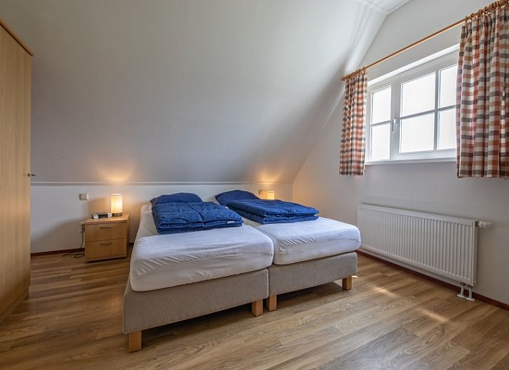 Gemuetliches Wohnzimmer von 't Mienthuis - De Jonker in De Dennen, Texel mit Blick auf gruene Felder.