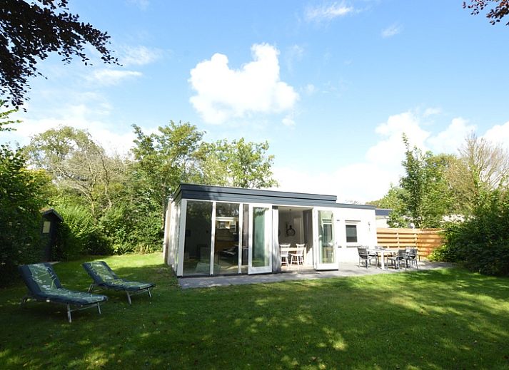 Helles Wohnzimmer im Ferienhaus Tempelierweg 16 - de Brunaire, De Dennen, Texel mit Blick auf den gruenen Garten, ideal fuer Familienurlaub.