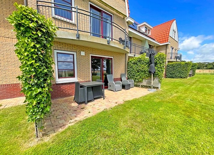 Gemuetliche Sitzecke mit Ledersofa im Apartment Bos en Duin 37, De Dennen, Texel, ideal zum Entspannen.