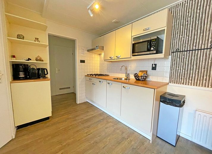 Lichte eetruimte in Appartement Bos en Duin 10, De Dennen, Texel met een moderne tafel en stoelen.