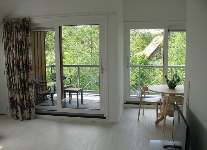 Vijverhof Ferienhaus fuer 6 Personen in De Dennen, Texel, umgeben von ueppiger Natur und mit einer einladenden Terrasse.
