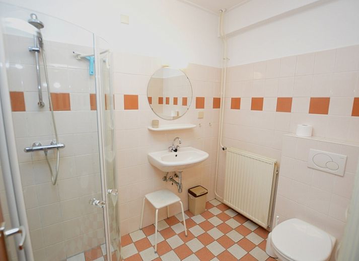 Comfortabele zitruimte in vakantiehuis Anjer, De Dennen, Texel met uitzicht op de tuin.