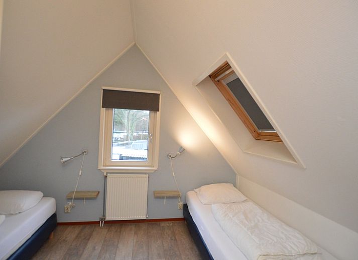 Cozy sitting area in Holiday home de Parel 214, De Dennen, Texel, overlooking the garden.