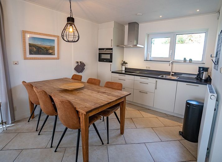 Cozy living room of Holiday Home 't Hoogelandt 136A in De Dennen, Texel with modern furnishings.
