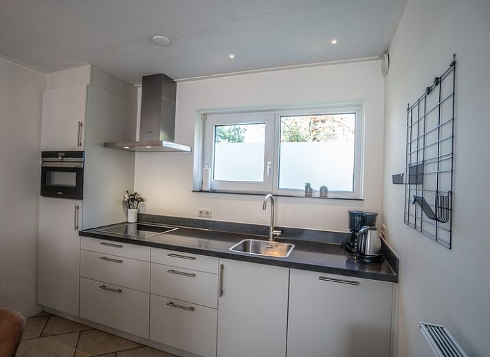 Cozy living room of Holiday Home 't Hoogelandt 136A in De Dennen, Texel with modern furnishings.