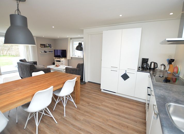 Geraeumiges Wohnzimmer des Ferienhauses de Parel 168 in De Dennen, Texel, mit moderner Einrichtung und viel natuerlichem Licht.