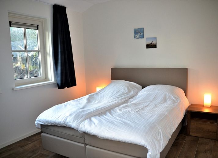 Cozy living room with wood stove in Golden Raand vacation home, Texel.
