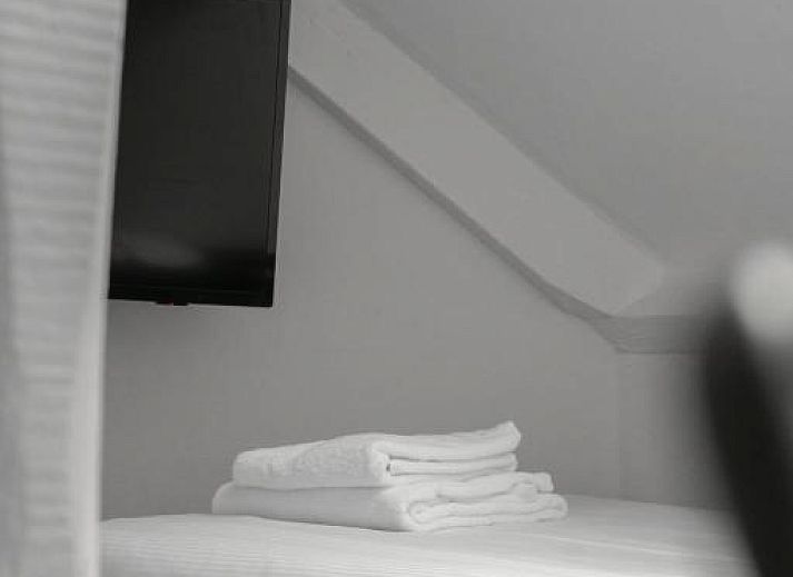 Soft towels made on bed at Hotel de la Bourse, comfortable stay in South Limburg, Maastricht.