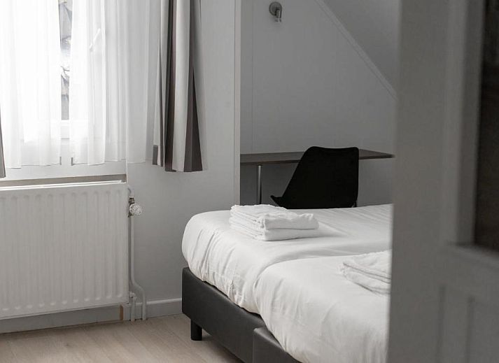 Soft towels made on bed at Hotel de la Bourse, comfortable stay in South Limburg, Maastricht.