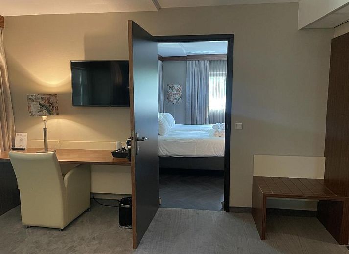 Luxe suite in Van der Valk Hotel Rotterdam - Blijdorp, elegant ingericht met een kingsize bed en zithoek.
