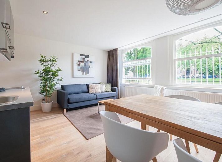 Private terrace of Museumpark Apartments, Rotterdam, with sitting area and French doors.