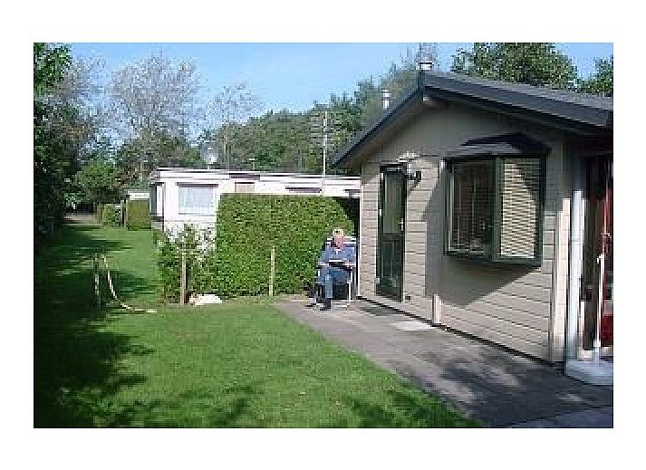 Cozy interior of De Mons chalet in Formerum, Terschelling with comfortable seating area.