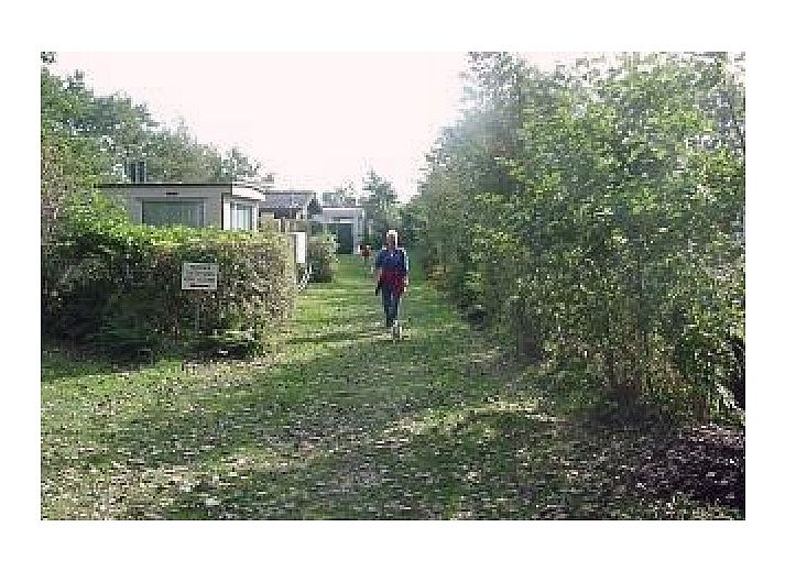 Cozy interior of De Mons chalet in Formerum, Terschelling with comfortable seating area.