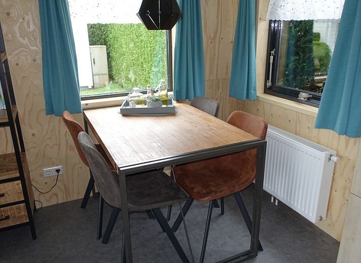 Noorderlicht vacation home in Formerum, Terschelling with wooden facade and cozy terrace.