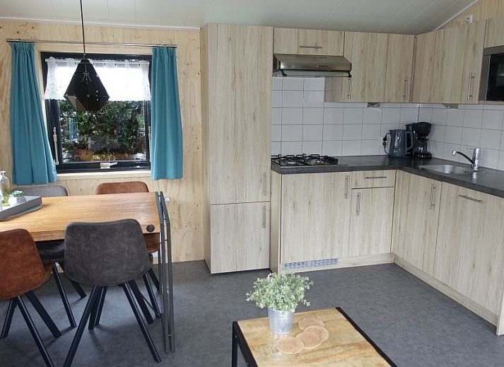 Cozy interior of Noorderlicht vacation home in Formerum, Terschelling with garden view.