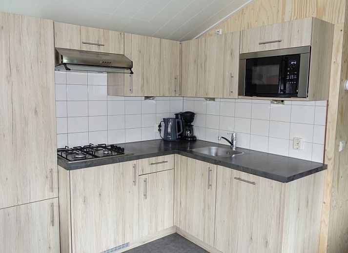 Cozy interior of Noorderlicht vacation home in Formerum, Terschelling with garden view.