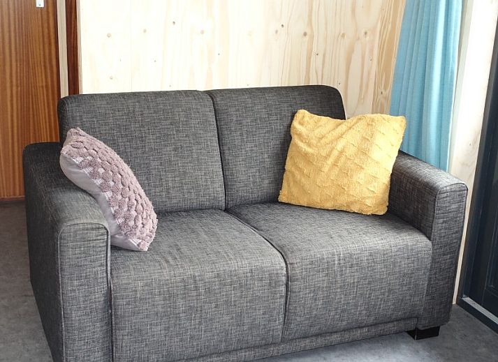 Cozy interior of Noorderlicht vacation home in Formerum, Terschelling with garden view.