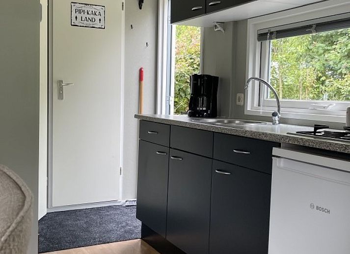 Exterior of vacation home Klaver Vier, Formerum, Terschelling, surrounded by lush greenery and a well-kept garden.