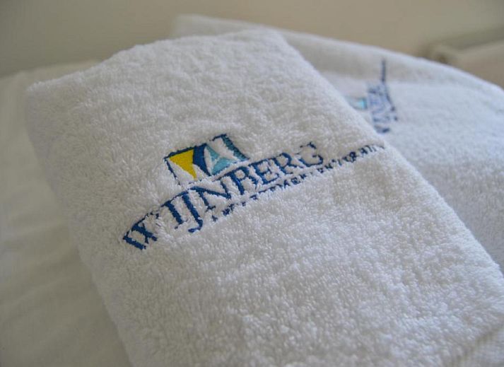 Moderne keuken in Wijnberg Appartementen, Hollum, Ameland met eettafel en apparatuur.