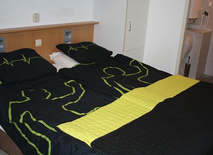 Comfortable bedroom in Apartment Amelander-Kaap TIME-OUT with SWIMMING POOL, Hollum, Ameland, ideal for a relaxing stay.