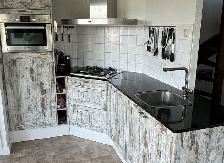 Terrace of De Hoek in Hoorn, Terschelling with comfortable seating and green surroundings.