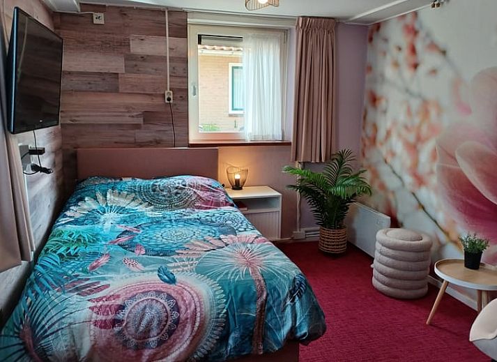 Comfortable bedroom in cottage in Oosterend, Terschelling overlooking the garden.
