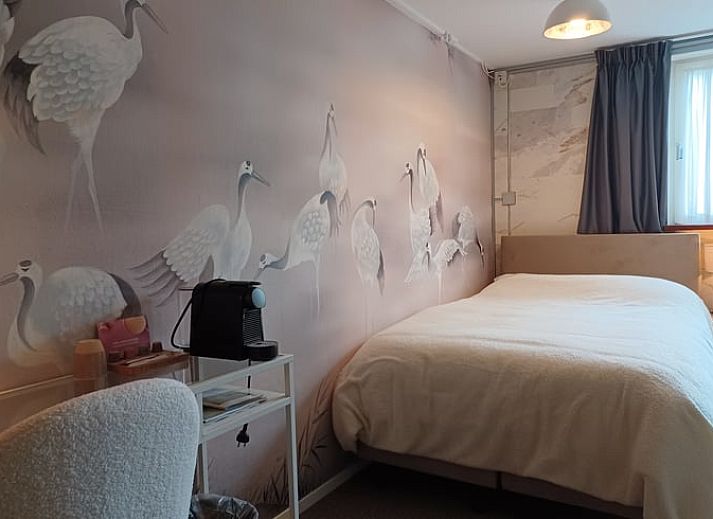 Comfortable bedroom in cottage in Oosterend, Terschelling overlooking the garden.