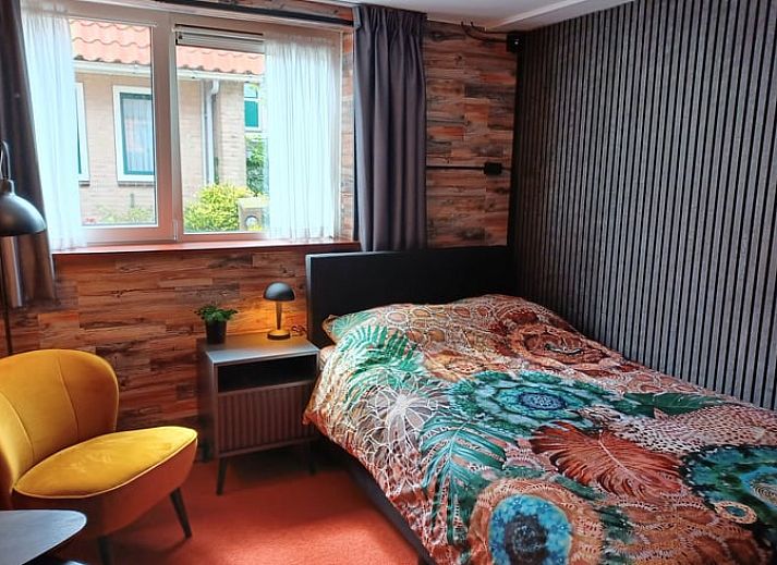 Comfortable bedroom in cottage in Oosterend, Terschelling overlooking the garden.