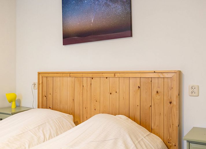 Apartment Bad Douche in Oosterend, Terschelling offers a sunny terrace with comfortable lounge chairs and an inviting garden setting.