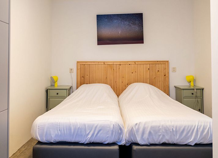 Apartment Bad Douche in Oosterend, Terschelling offers a sunny terrace with comfortable lounge chairs and an inviting garden setting.