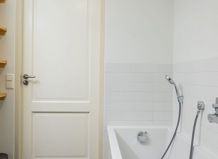 Cozy bedroom in Apartment Bath Douche, Oosterend, Terschelling with wooden headboard and atmospheric lighting.