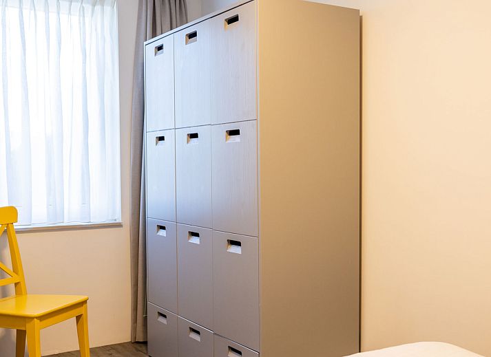 Cozy bedroom in Apartment Bath Douche, Oosterend, Terschelling with wooden headboard and atmospheric lighting.