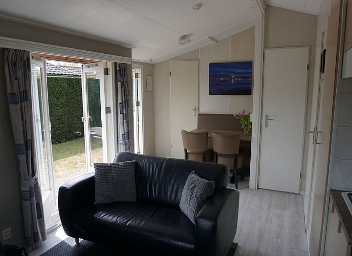 Cozy terrace at Dunamar chalet, Midsland Noord, Terschelling, with deck chairs and garden table.