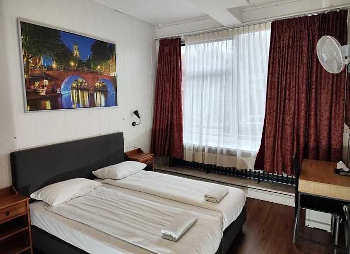 Moderne slaapkamer in Hotel Holland Lodge, Utrecht met comfortabel bed en houten accenten.