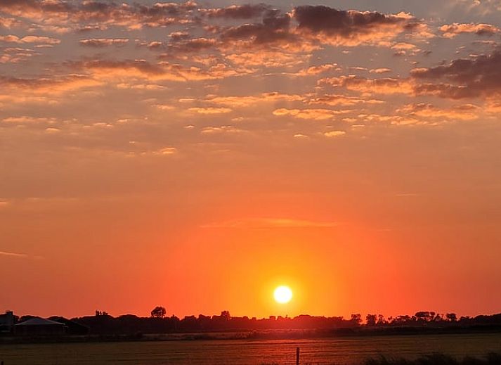 Gezellige woonkamer in Vakantiehuis in Ballum, Ameland, met comfortabele stoelen.