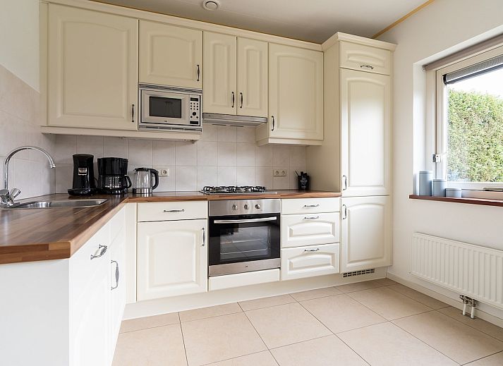 Vakantiehuis Meidoorn in Ballum, Ameland met charmante houten buitenkant en rode dakpannen.